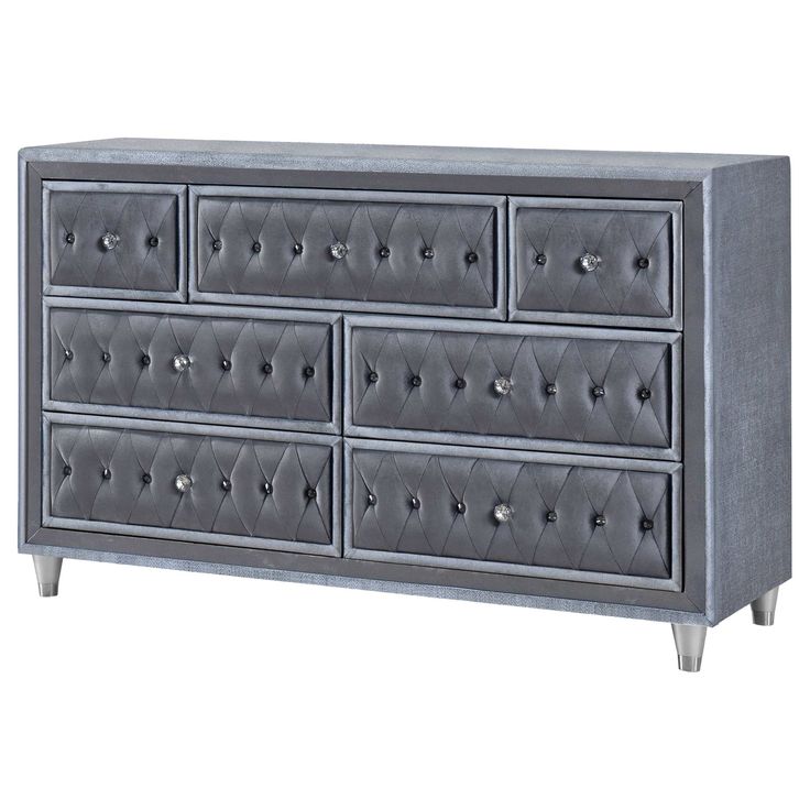 a gray dresser with many drawers and knobs