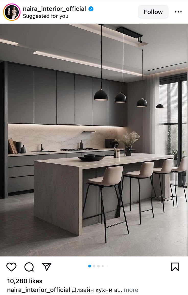 an image of a modern kitchen with grey cabinets and white counter tops, along with bar stools