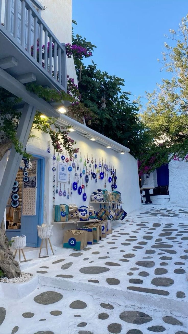 a white building with lots of decorations on the outside wall and stairs leading up to it