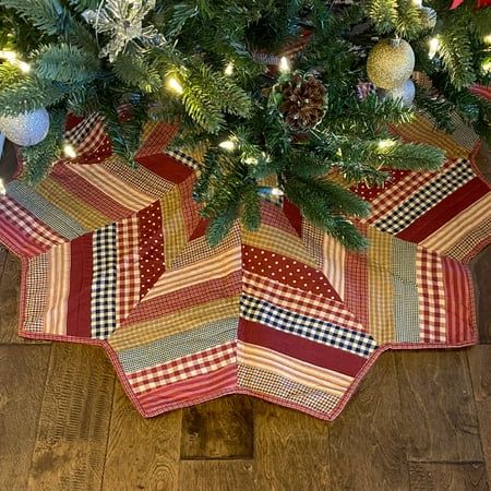 a christmas tree skirt is hanging on the floor