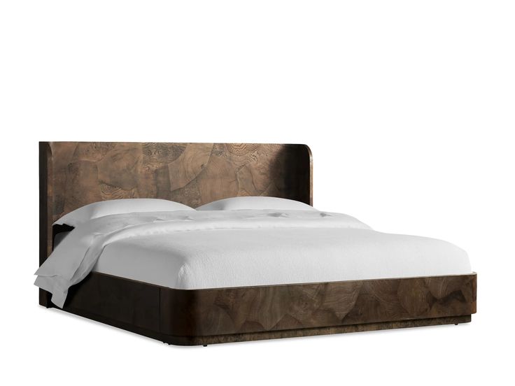 a bed with a wooden headboard and white sheets