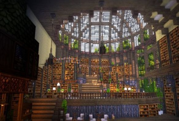 the inside of a library with lots of bookshelves and stairs leading up to it