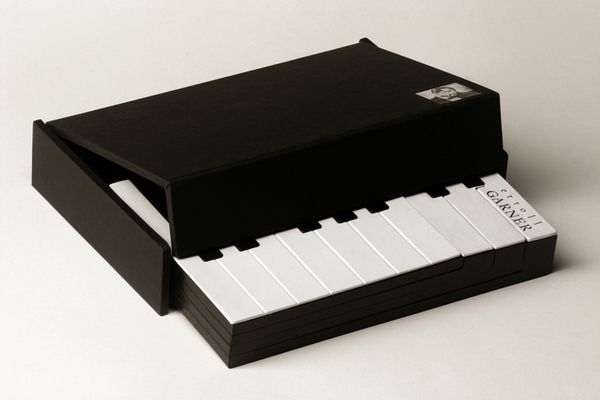 a small black box with white keys and a piano keyboard in the bottom right corner