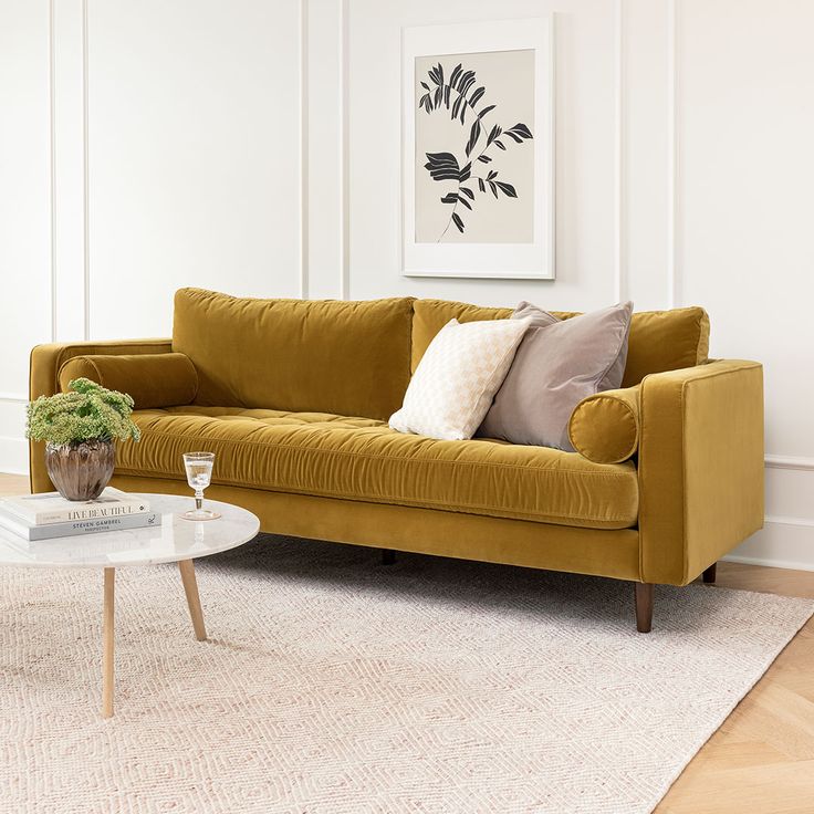 a living room with a yellow couch and coffee table