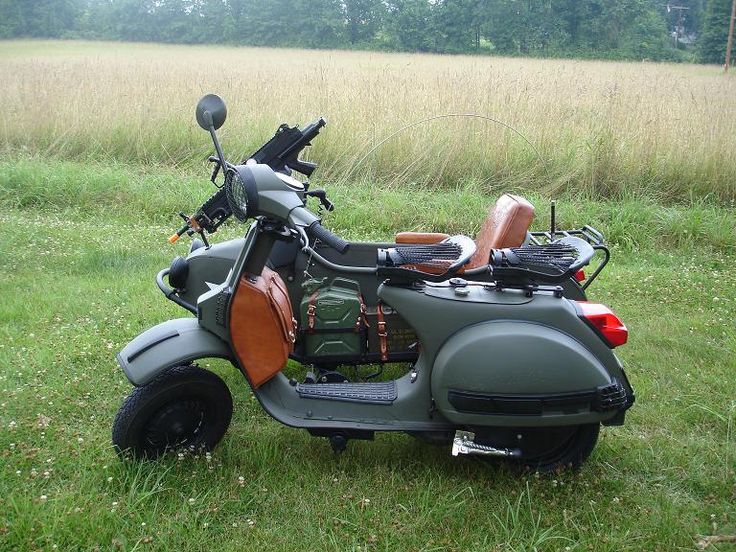 a motorcycle is parked in the grass near some trees