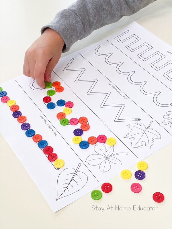 a child is making a letter recognition activity with buttons