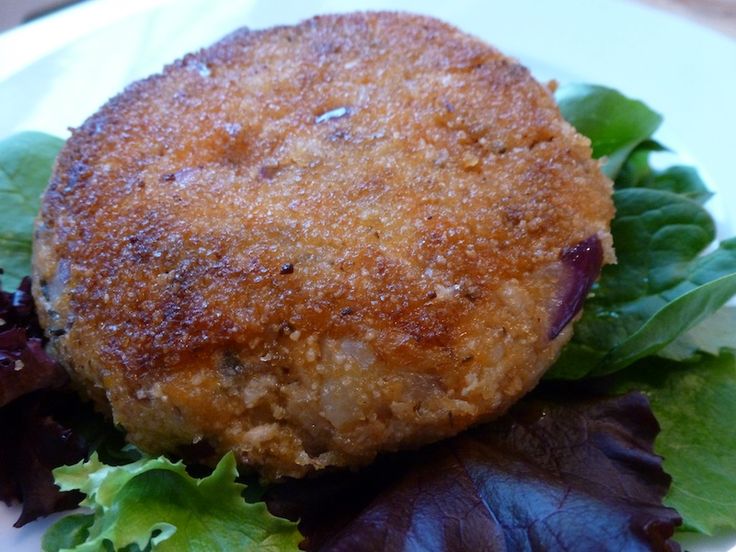 a close up of a plate of food with lettuce and meat patties