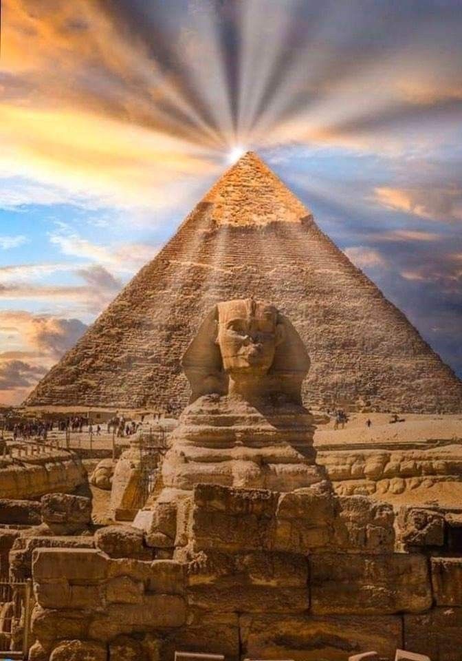 an image of the great sphinx and pyramids in giza, egypt with sun rays coming through