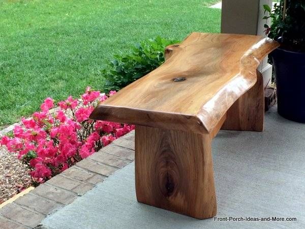 a wooden bench sitting on top of a sidewalk