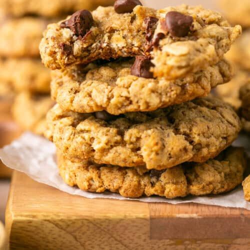 chocolate chip oatmeal cookies stacked on top of each other with one cookie in the middle