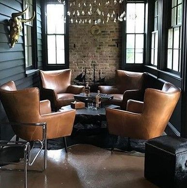 a living room filled with lots of brown furniture