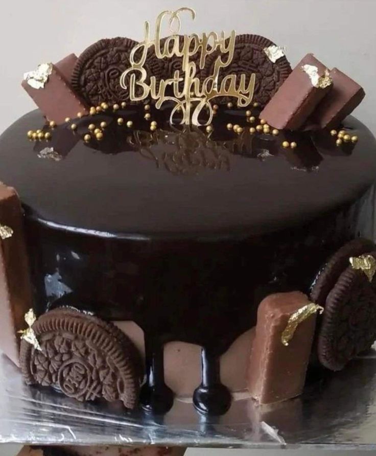 a chocolate birthday cake with cookies on top