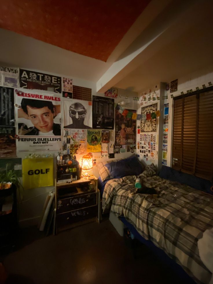 a bedroom with posters on the wall and a bed in it's center area