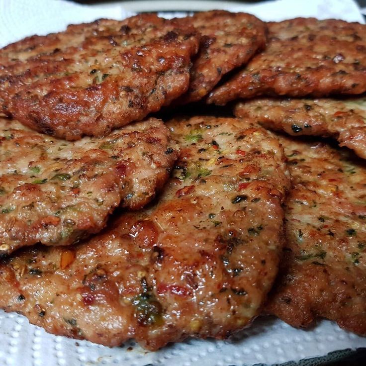 some meat patties are on a white plate