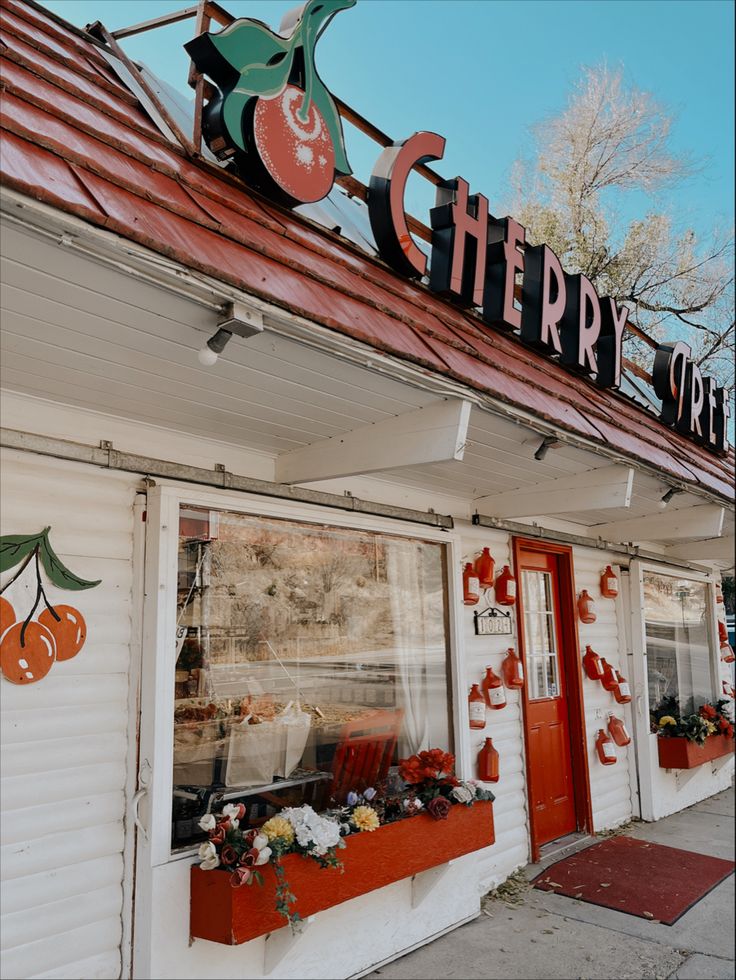 the front of a store that sells cherries and other items