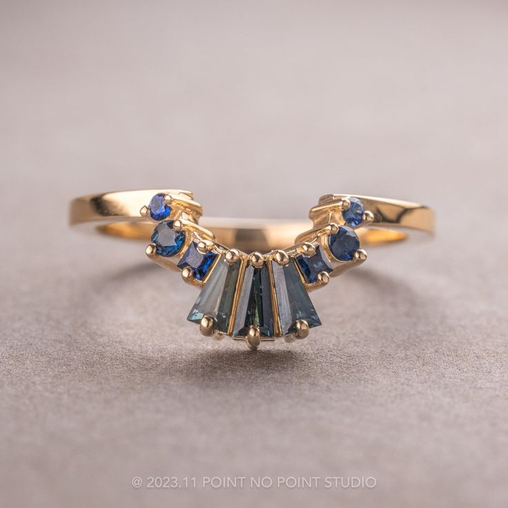 a gold ring with blue stones on it