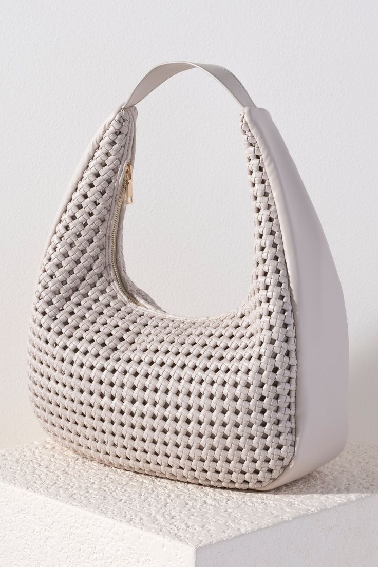 Carry all of your summer essentials in style with Shiraleah's Monroe Hobo. Made of elegant handwoven vegan leather, this purse is your new favorite summer handbag. Its single shoulder strap allows you to wear it easily over your arm. Pair with other items from Shiraleah to complete your look! White Shoulder Bag With Braided Handles For Day Out, Casual Woven Leather Hobo Bag For Daily Use, Everyday Crochet Bag With Woven Leather And Double Handle, Casual Woven Leather Hobo Shoulder Bag, Trendy Open Weave Shoulder Bag For Daily Use, Trendy Beige Hobo Bag With Braided Handles, Chic Braided Shoulder Bag For Daily Use, Chic Double Handle Braided Bag, Elegant Woven Leather Crochet Bag For Daily Use