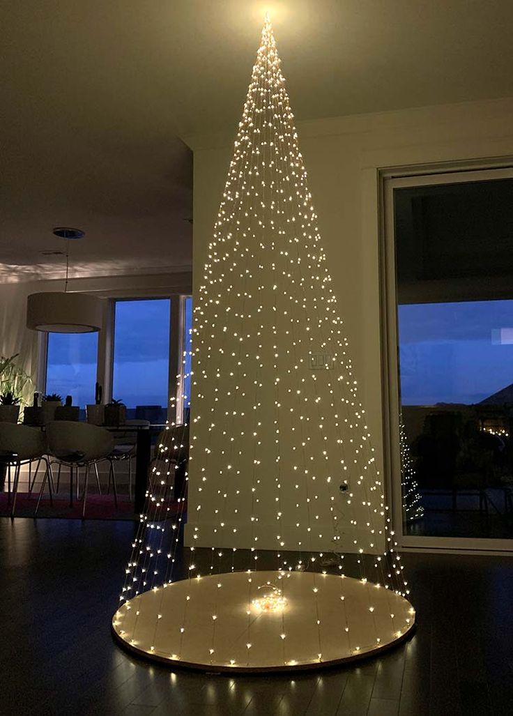 a lighted christmas tree in the middle of a room