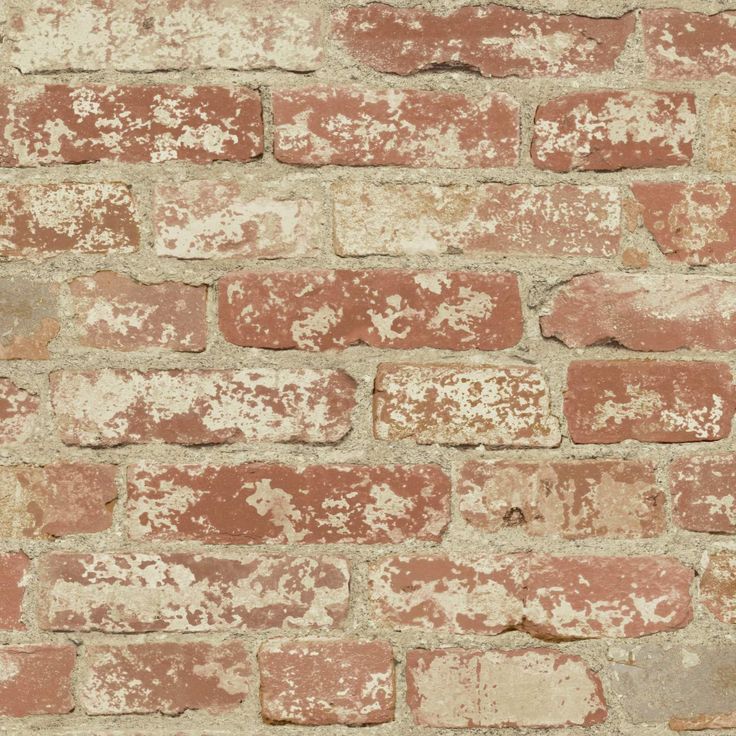 an old brick wall with white and red paint