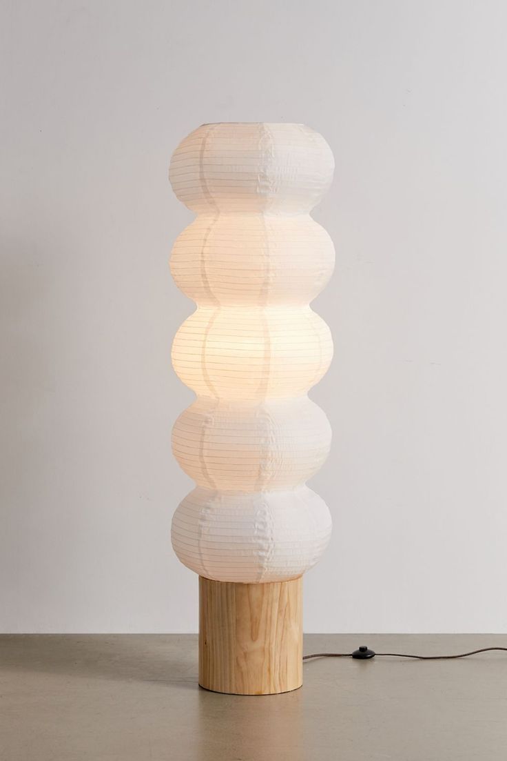 a white lamp sitting on top of a wooden table