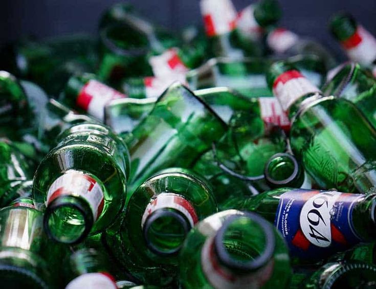 a pile of green and red soda bottles