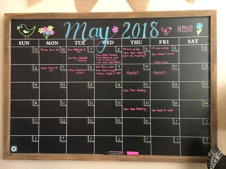 a chalkboard calendar hanging on the wall