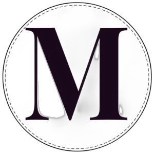 the letter m is inscribed in black and white with a stitched border around it