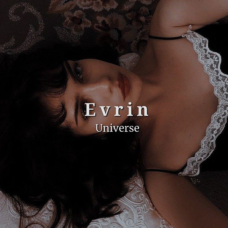 a woman laying on top of a bed next to a flowered wallpaper with the words evrin universe