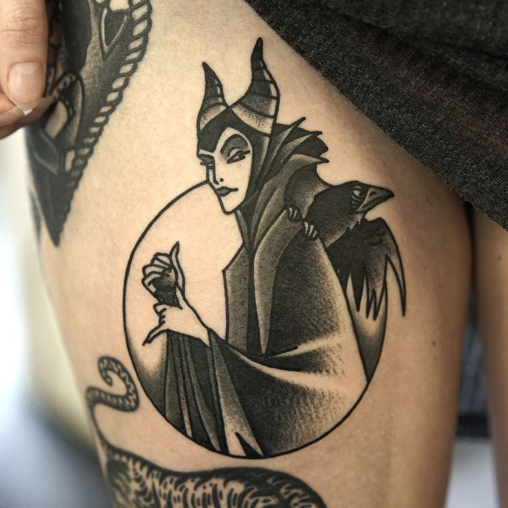 a woman's thigh with an image of the evil queen in black and white