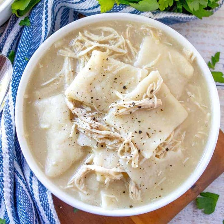 a white bowl filled with chicken noodle soup