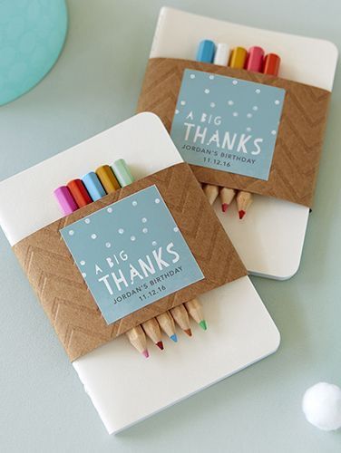 two small wooden crayons sitting on top of a white board next to each other