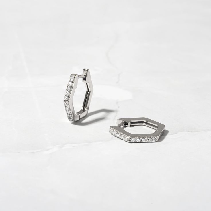 These geometric shaped huggie hoops are dainty and minimalist and so stylish! They look great stacked or on their own! Made of 925 Sterling Silver We use a THICK plating of 14k Gold or Rhodium (for a piece that will be with you for years to come) Nickel-free & Hypoallergenic (great for sensitive ears!) Inner Diameter: 9.5mm Sold as a pair Made of the highest quality cubic zirconia for an authentic diamond look! ✻ Earrings on Model ✻Plain Huggies 2mm Stud Earrings 🎁 Comes in a gift-box, ready fo Huggie Hoop Earrings, Sensitive Ears, Silver Hoop Earrings, Precious Metals, Gold Earrings, Silver Gold, Cubic Zirconia, Gift Box, Hoop Earrings