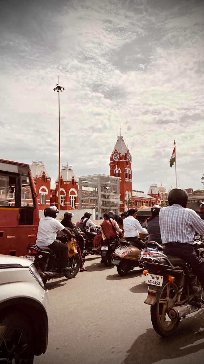 several people riding motorcycles on a city street