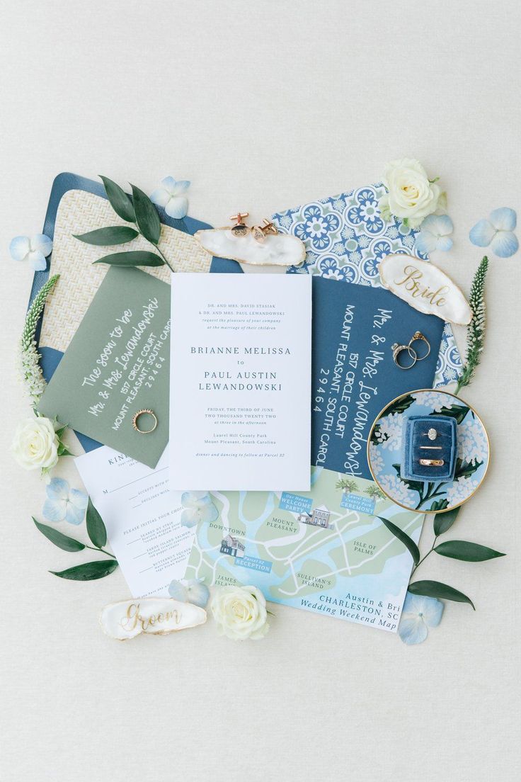 the wedding stationery is laid out on top of each other