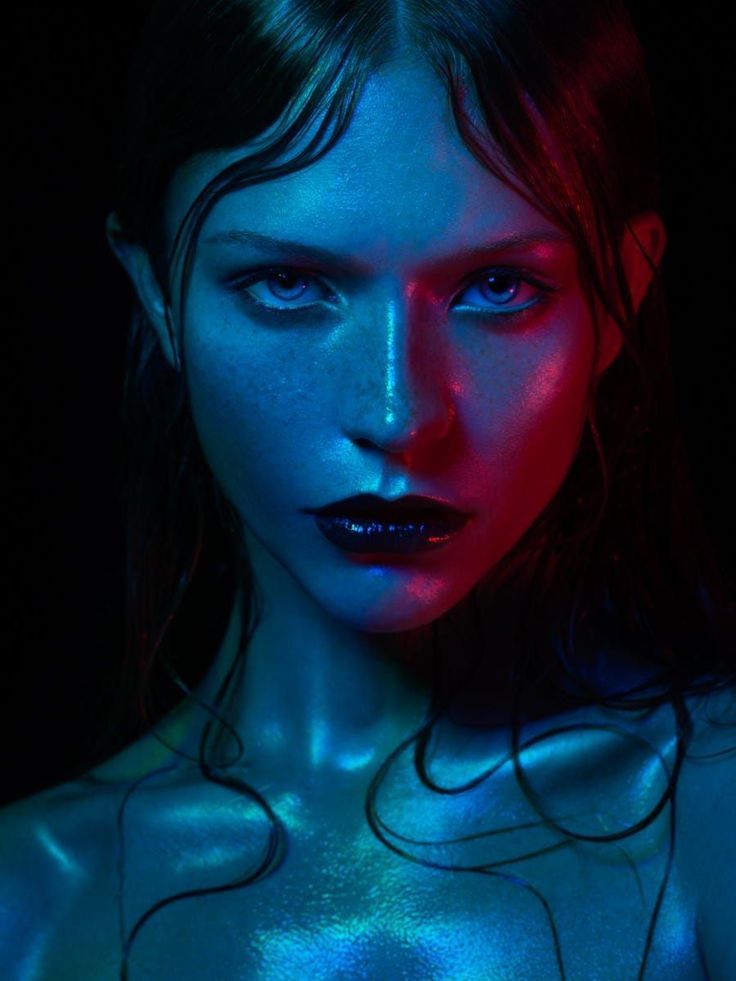 a woman with blue and red light on her body