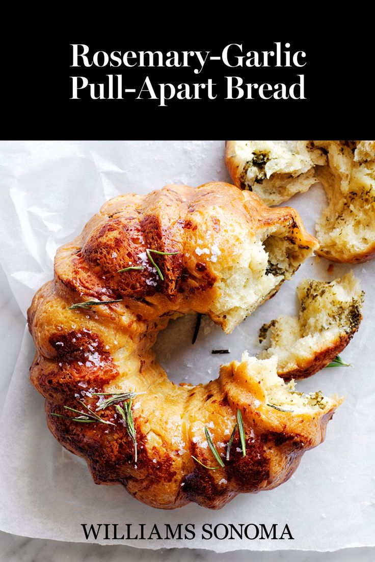 rosemary - garlic pull - apart bread is shown on a piece of parchment paper with the title, rosemary garlic pull - apart bread