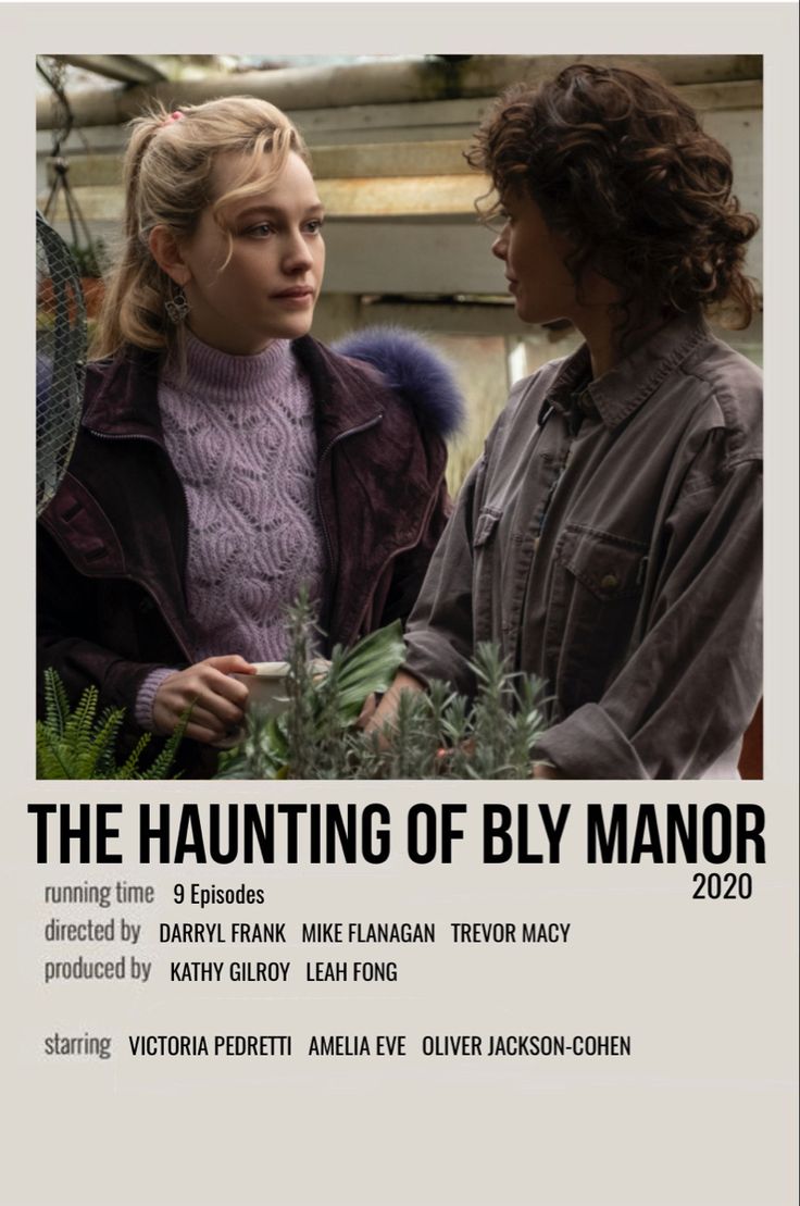 two women standing next to each other in front of an advertisement for the hunting of bly manor