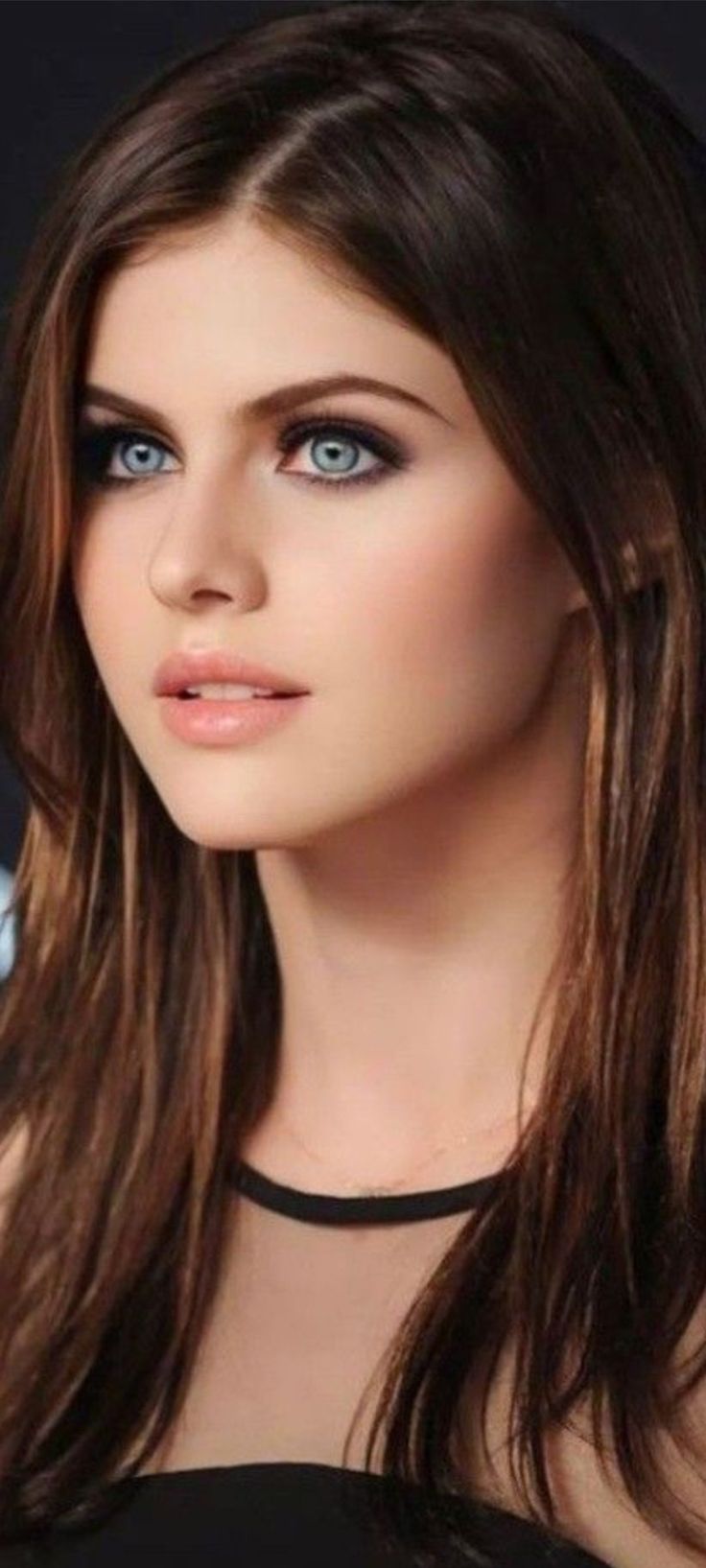 a woman with long brown hair and blue eyes