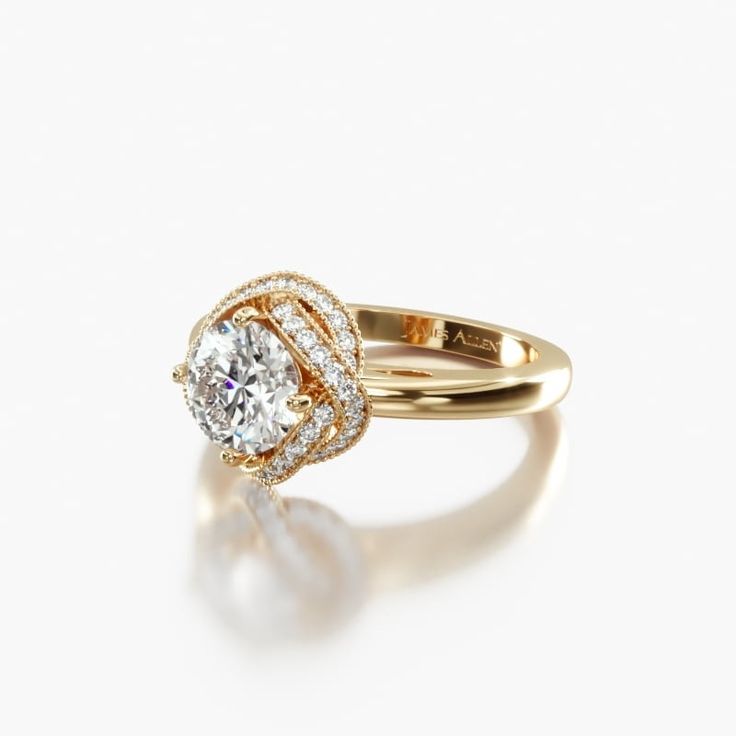 a yellow gold ring with an oval diamond in the center