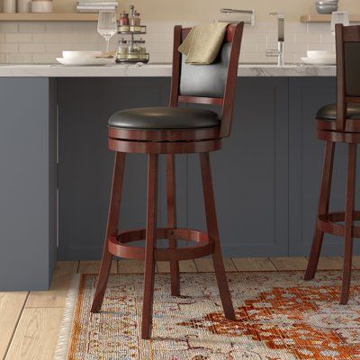 two stools in front of a kitchen island with an area rug on the floor