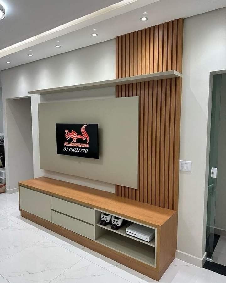 a large television mounted on the wall in a room with white tile flooring and wood paneling