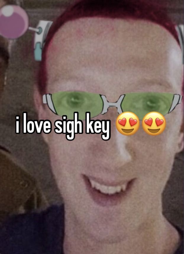 a man with red hair and green glasses has the words i love sigh key on his face