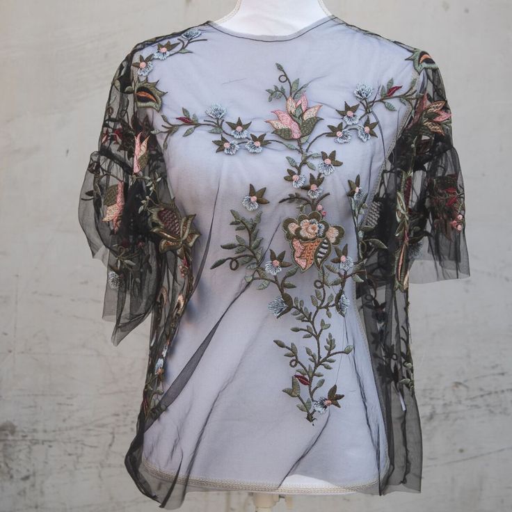 This Sheer, Floral Blouse Is An Elegant Piece To Paired With Jeans And A Wedge Heel. It's Perfect For A Fun Night Out With Your Girlfriends Or A Date Night. Summer Floral Print Blouse For Night Out, Feminine Evening Tops With Sheer Sleeves, Fitted Floral Embroidery Blouse For Night Out, Black Blouse With Floral Embroidery For Night Out, Chic Floral Embroidered Top For Evening, Spring Short Sleeve Blouse For Night Out, Black Top With Floral Embroidery For Night Out, Spring Night Out Blouse With Floral Embroidery, Chic Evening Tops With Floral Embroidery