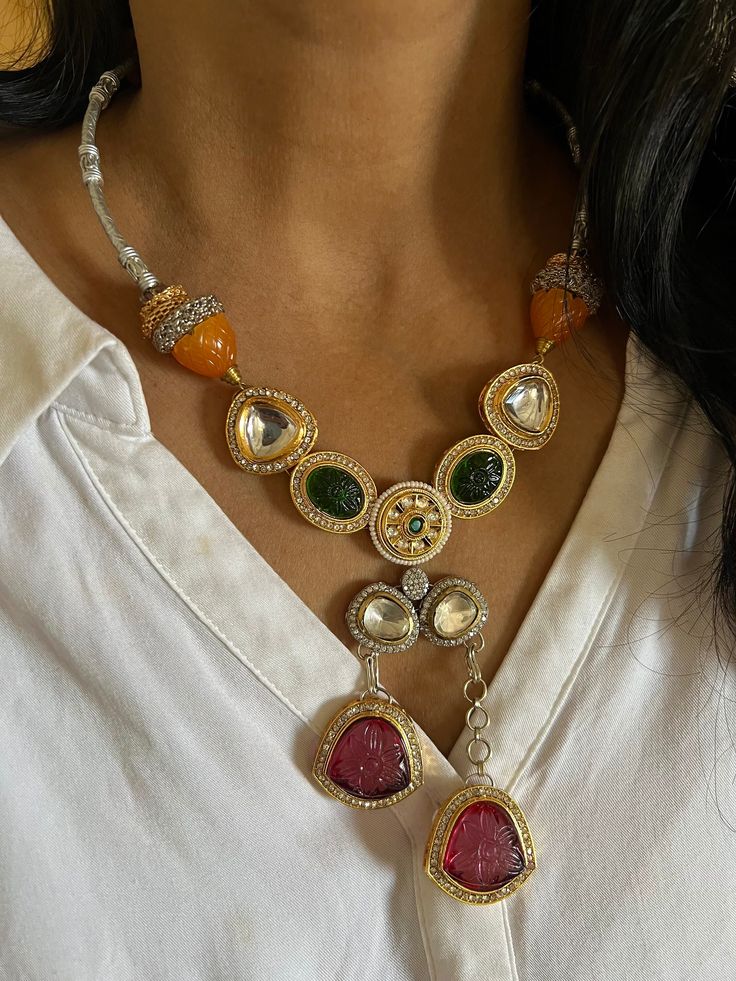 New arrivals for the festival season ♥️ The gorgeous necklace is beautifully handcrafted by our skilled Indian craftsmen in Kundan stones, beads, multi-colored stones, mini pearls, and dual tone plated. The beautiful Statement earrings add to the traditional ethnicity of the piece. Material: Brass with dual-tone plating The drop length of the necklace is 10 inches. It comes with Dori and is adjustable. The length of the earrings is 4.5 cm. The width of the earrings is 3 cm. The weight of the earrings is 24 grams per pair. This is one of a kind designer piece that will make you stand out among the crowd. Luxury Heavy Fusion Necklaces, Elegant Multicolor Dual-tone Jewelry, Fusion Style Multicolor Teardrop Jewelry, Multicolor Teardrop Fusion Jewelry, Kundan Multi-stone Necklace As Gift, Silver Beaded Jewelry For Festivals, Silver Beaded Festival Jewelry, Traditional Multi-stone Necklace For Gift, Multicolor Dual-tone Fusion Jewelry