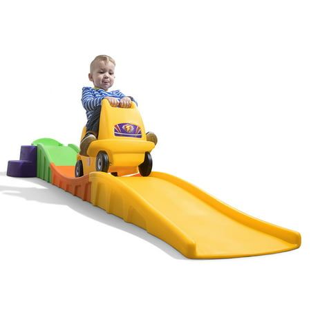 a toddler playing on a yellow slide