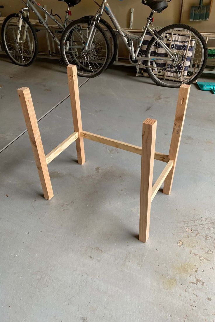 two bikes are parked next to each other in a bike storage area with wooden posts