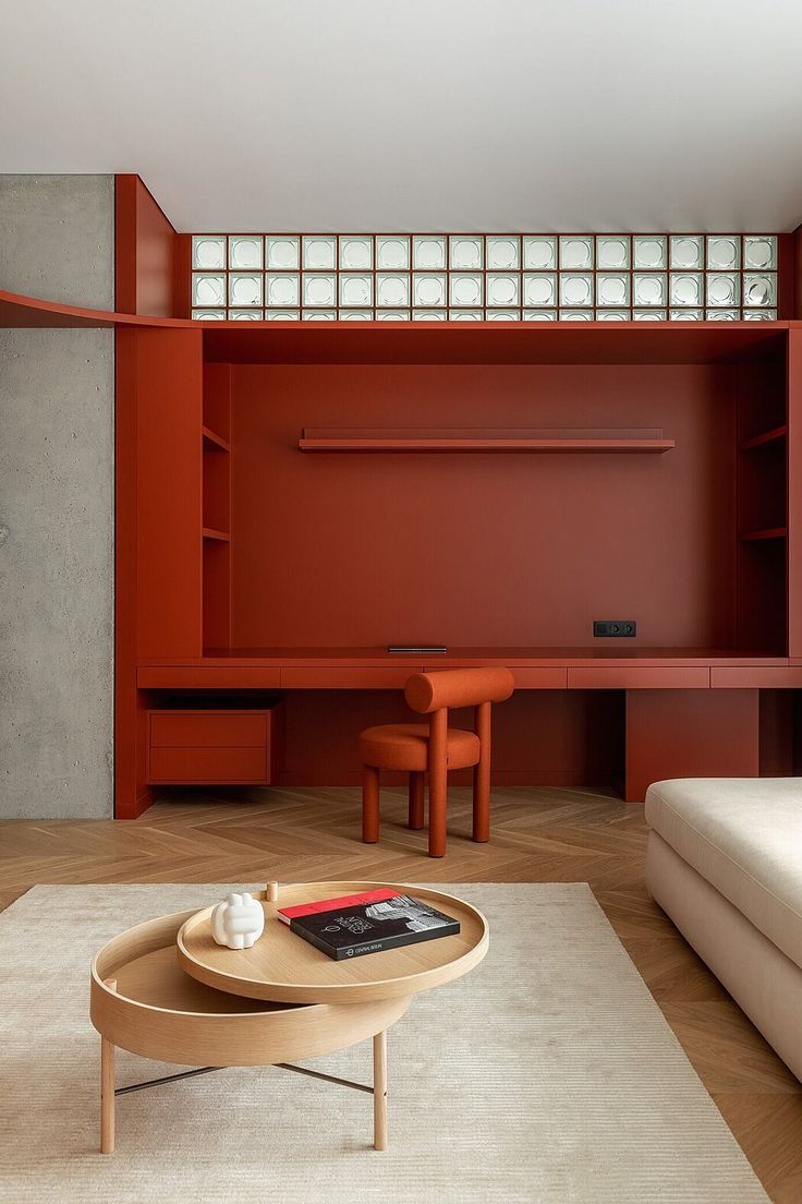 a living room with red walls and furniture