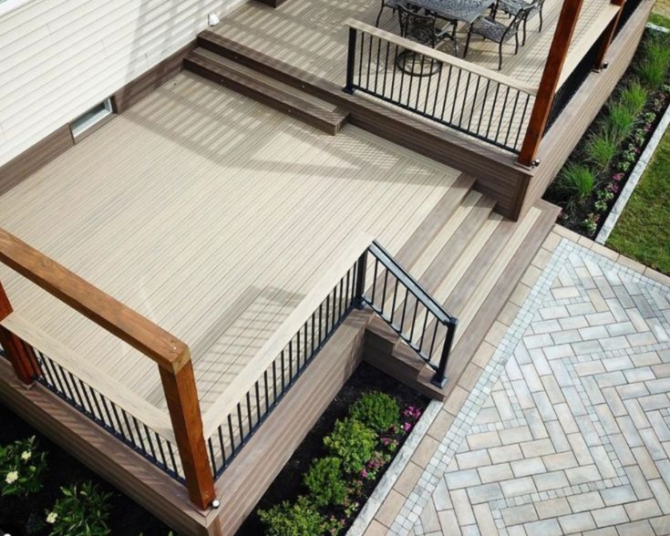 a deck with steps leading up to an outdoor dining area