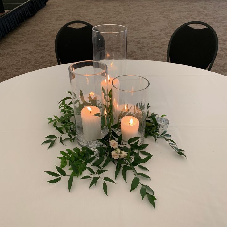 some candles are sitting on a white table