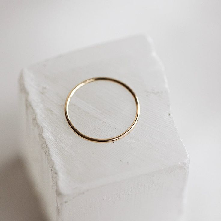 The Bare Gold Stacker is a smooth, solid gold 1mm band and a true go-to for any stack. This skinny ring is so versatile, giving a subtle option that stands alone, while also effortlessly adding a splash of golden shine to your stack. The Bare Gold Stacker is our #1 bestselling ring, both online and in-store, and is a classic piece that will make you feel golden. We are positive you'll never want to take this one off! Simple 14k Gold Stackable Rings Tarnish Resistant, 14k Yellow Gold Midi Rings For Everyday, 14k Gold Hoop Rings For Everyday, Classic Yellow Gold Midi Rings For Everyday, Everyday Yellow Gold 14k Midi Rings, Minimalist Round Bands With Simple Design, Everyday 14k Gold Hoop Rings, Everyday 14k Yellow Gold Midi Rings, Minimalist Everyday Bands Tarnish Resistant